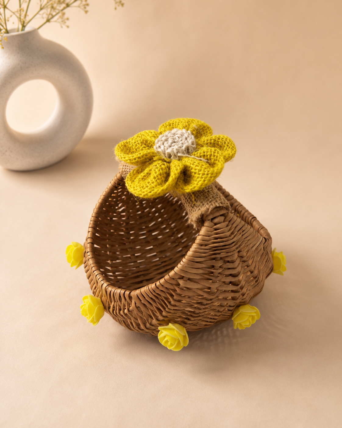 A small woven cane basket decorated with a yellow flower and matching accents, ideal for wedding favours, festive treats, return gifts, and small hampers.
