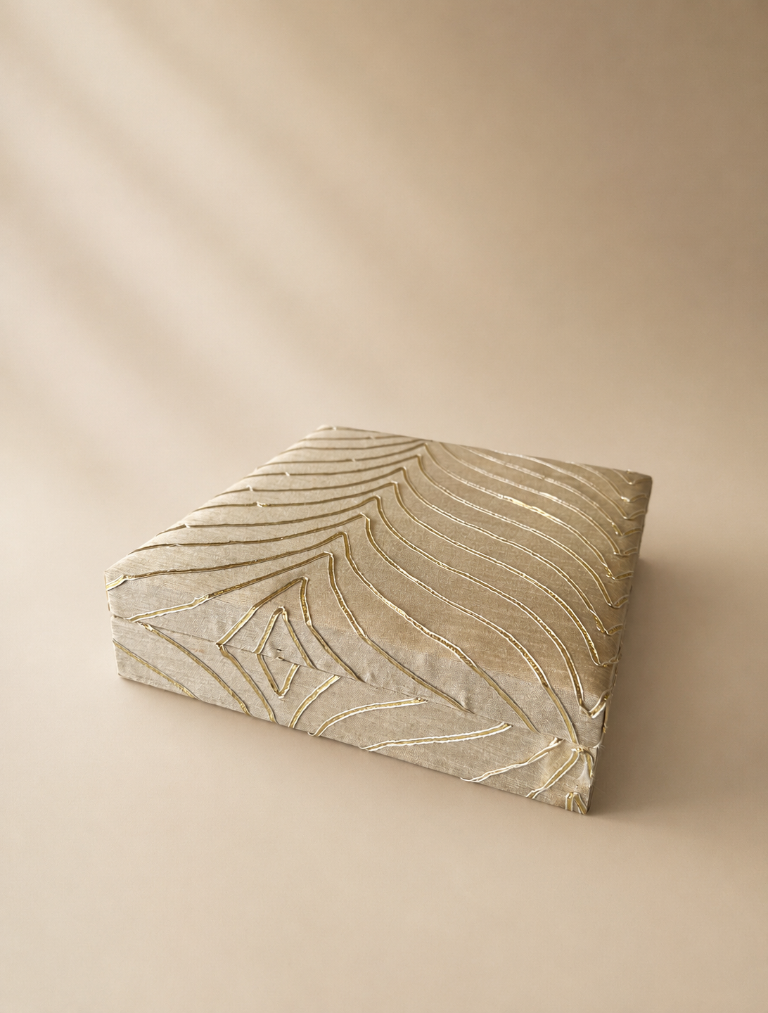 An off-white half-kilogram mithai box with a subtle golden embossed leaf pattern and fitted lid, designed for sweets, Diwali gifting, weddings, and festive celebrations.