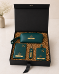 A premium black gift box featuring a personalized passport cover, utility pouch, luggage tag, keychain, and shredded paper packaging for elegant travel-themed gifting.