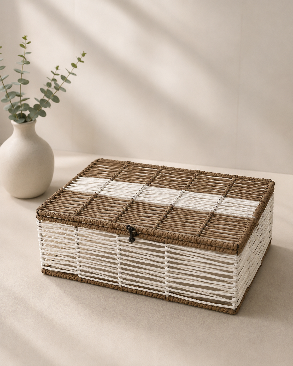 A white and brown woven trunk hamper box with a contrasting brown lid and rectangular design, suitable for dry fruits, sweets, chocolates, wellness products, and curated gifts.