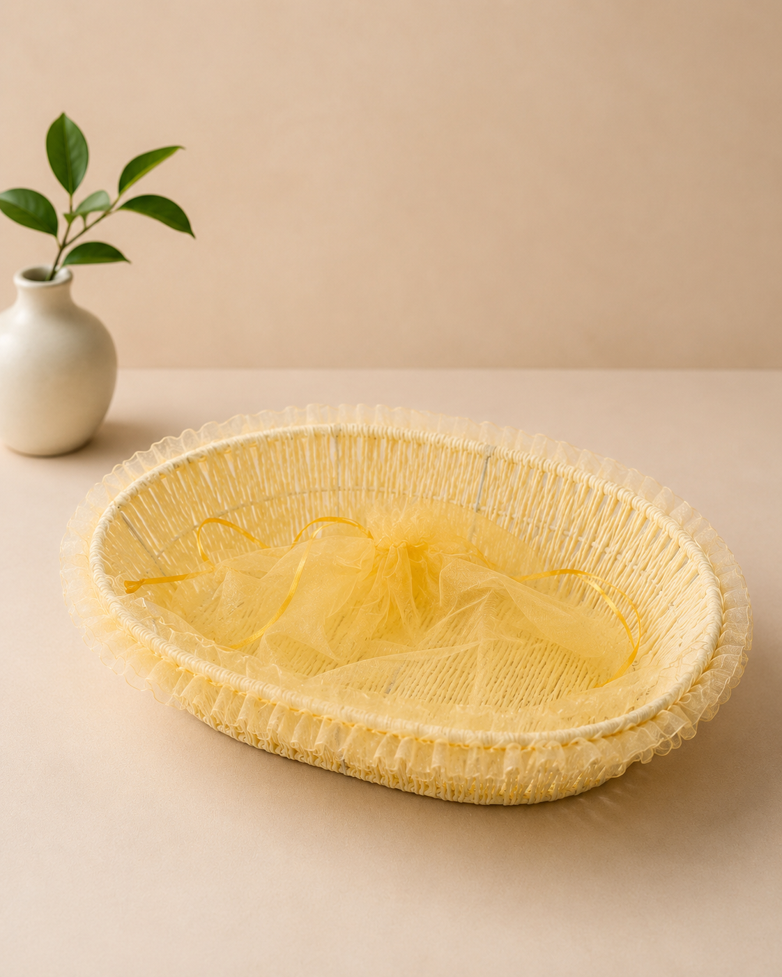 A shallow yellow net tokri with a delicate woven design, suitable for presenting flowers, sweets, dry fruits, chocolates, and small festive gifts.