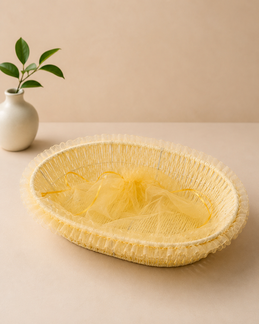 A shallow yellow net tokri with a delicate woven design, suitable for presenting flowers, sweets, dry fruits, chocolates, and small festive gifts.