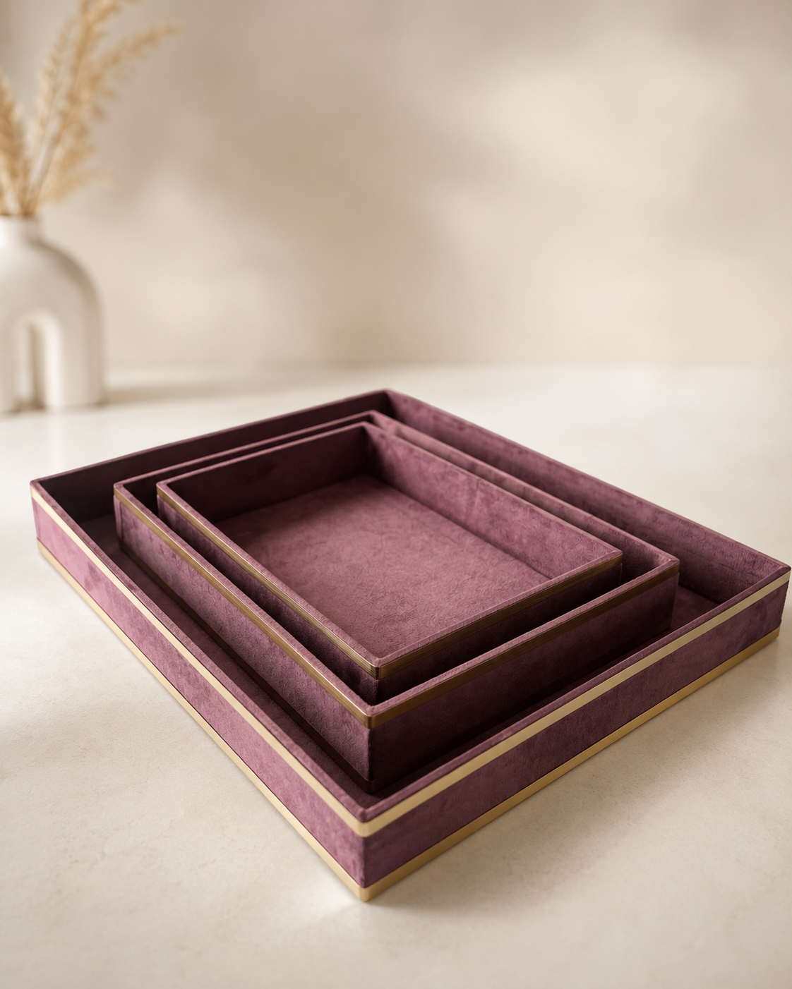 A set of layered pink suede trays with contrasting golden borders in different rectangular sizes, suitable for jewellery, sweets, dry fruits, candles, and premium gift arrangements.
