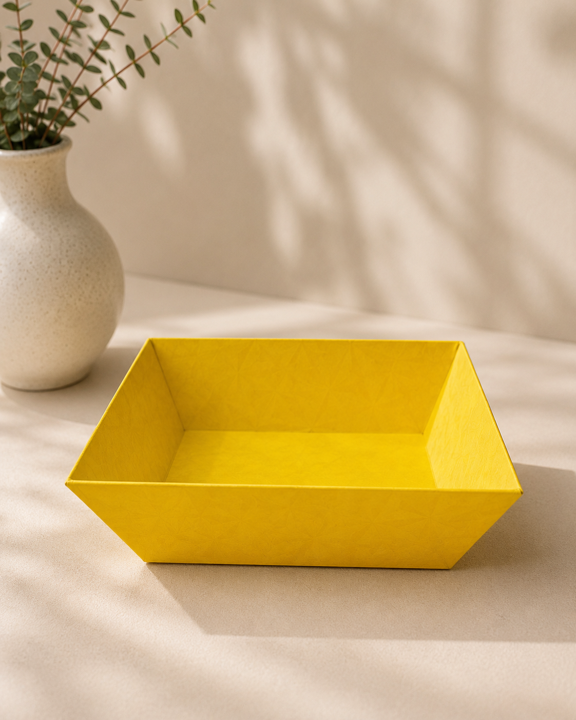 A bright yellow open-top cardboard tray designed for arranging sweets, chocolates, dry fruits, and small products in festive gift hampers and return gifts.