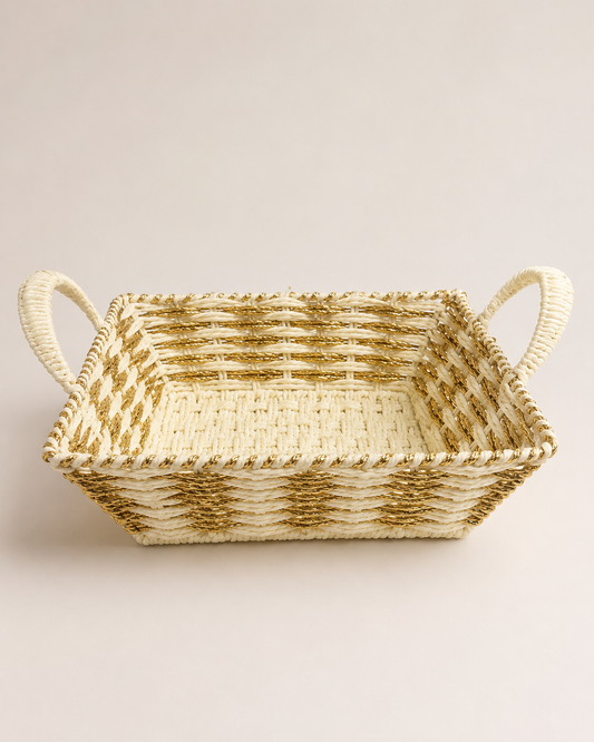 An off-white and golden square woven basket with two side handles, ideal for presenting sweets, dry fruits, chocolates, candles, and festive gifts.