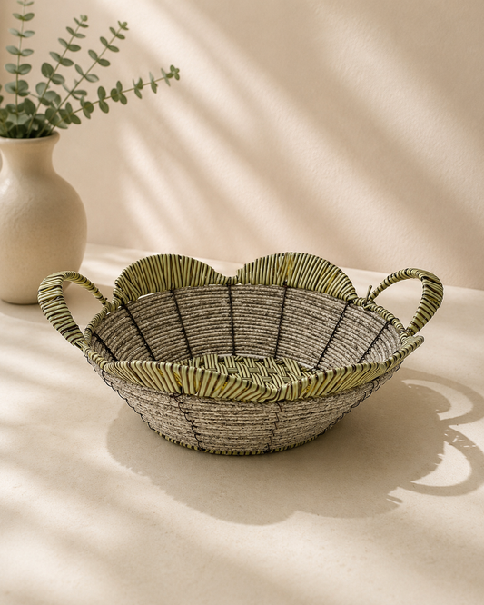 A green woven flower-shaped tokri with scalloped edges and small side handles, suitable for sweets, dry fruits, flowers, return gifts, and festive hampers.