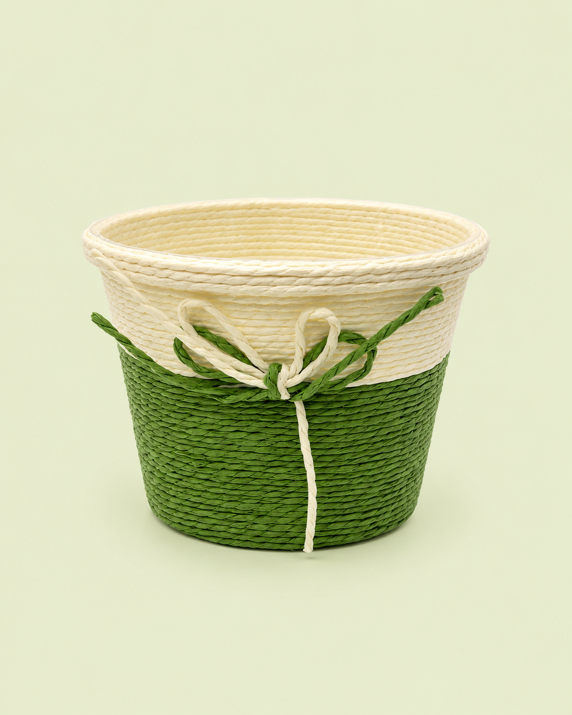 A small green and natural woven gift basket with a decorative bow, ideal for gourmet hampers, housewarming gifts, festive favours, and elegant gift presentations.