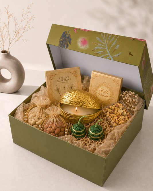 Golden Spark Hamper in an olive green Kappa box with a festive candle, fire crackers, dry-fruit potlis, savoury snacks, coaster set, and decorative accents.