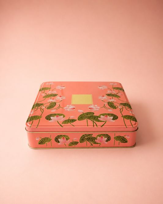 A peach printed tin hamper box with a floral pattern, metallic interior, and fitted lid, suitable for chocolates, dry fruits, sweets, keepsakes, and curated gifts.