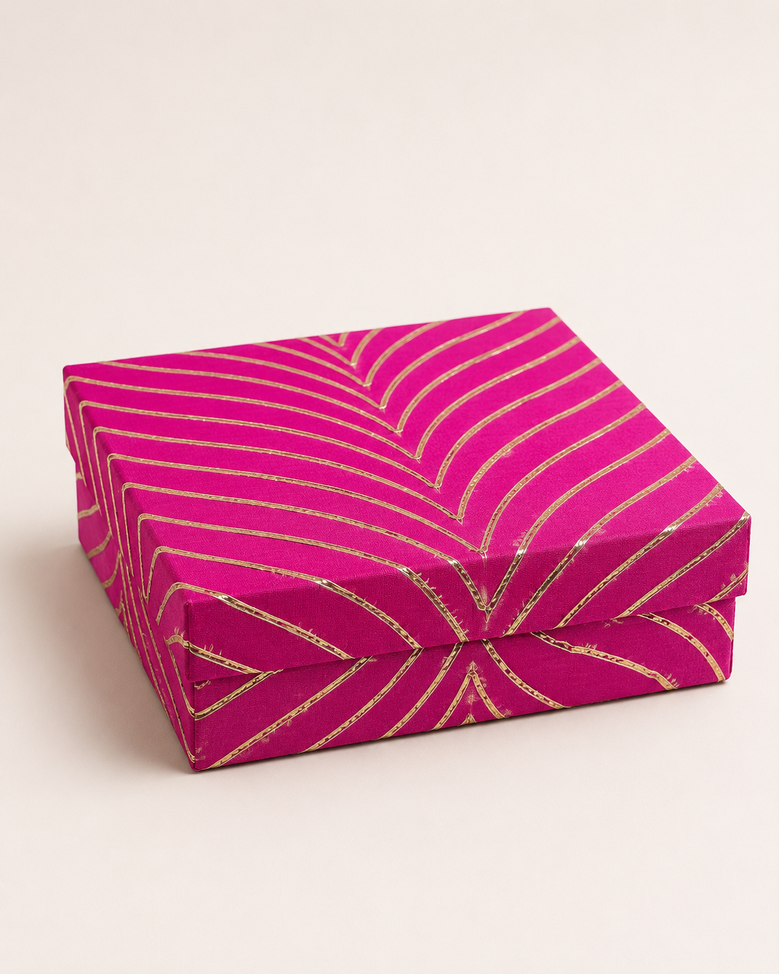 A pink and gold half-kilogram mithai box with a bold chevron pattern, designed for presenting traditional sweets, confectionery, and festive gifts.