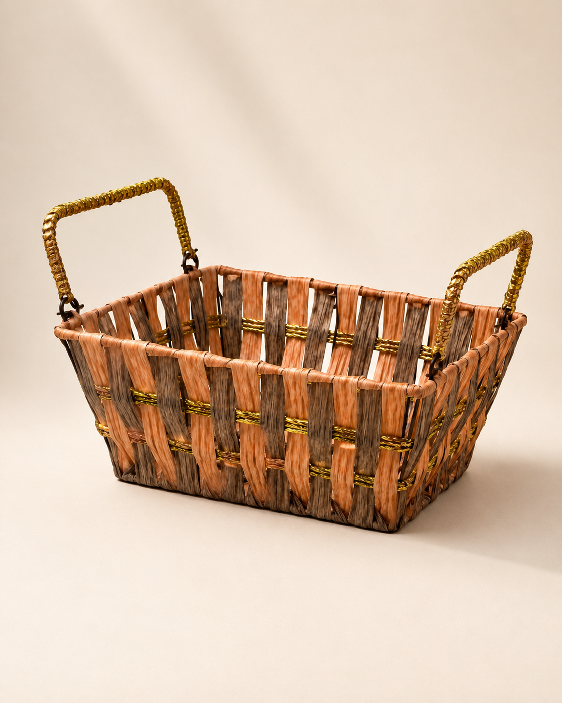 An orange and brown woven rectangular basket with two handles, suitable for creating festive hampers, dry fruit gifts, floral arrangements, and curated gift sets.