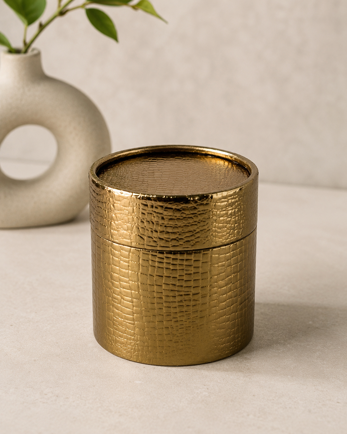 A dark golden textured cylindrical metal gift box with a matching lid, ideal for premium hampers, gourmet treats, chocolates, dry fruits, and elegant festive gifting.