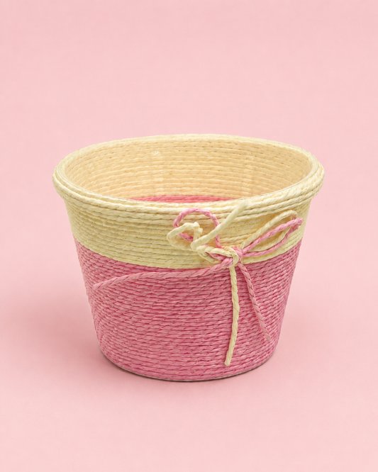 A small pink and natural woven gift basket with a decorative bow, ideal for floral arrangements, sweets, beauty gifts, return favours, and festive hamper presentations.