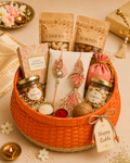 A reusable woven basket featuring Bhaiya Bhabhi Rakhi, kids Rakhis, chocolates, dry fruits, festive potli, roli chawal set, and decorative styling for family Raksha Bandhan gifting.
