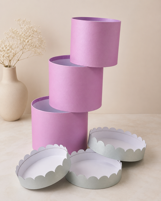 A set of pastel pink round nesting gift boxes with matching white scalloped trays, designed for gift hampers, floral arrangements, chocolates, and festive packaging.