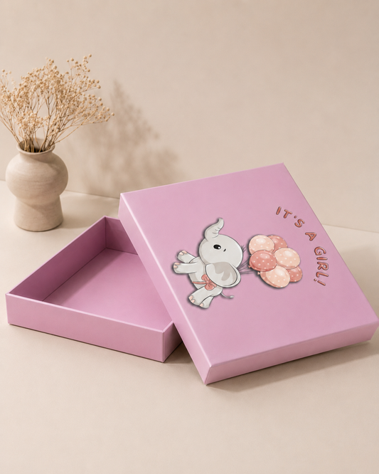 A pastel pink hamper box with a cute baby-themed illustration on the lid, ideal for baby girl showers, newborn gifts, keepsakes, and baby hampers.