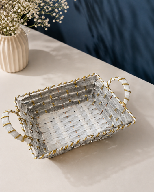 A grey and golden square woven basket with two side handles, designed for festive hampers, corporate gifts, wedding favours, chocolates, dry fruits, and curated gift sets.