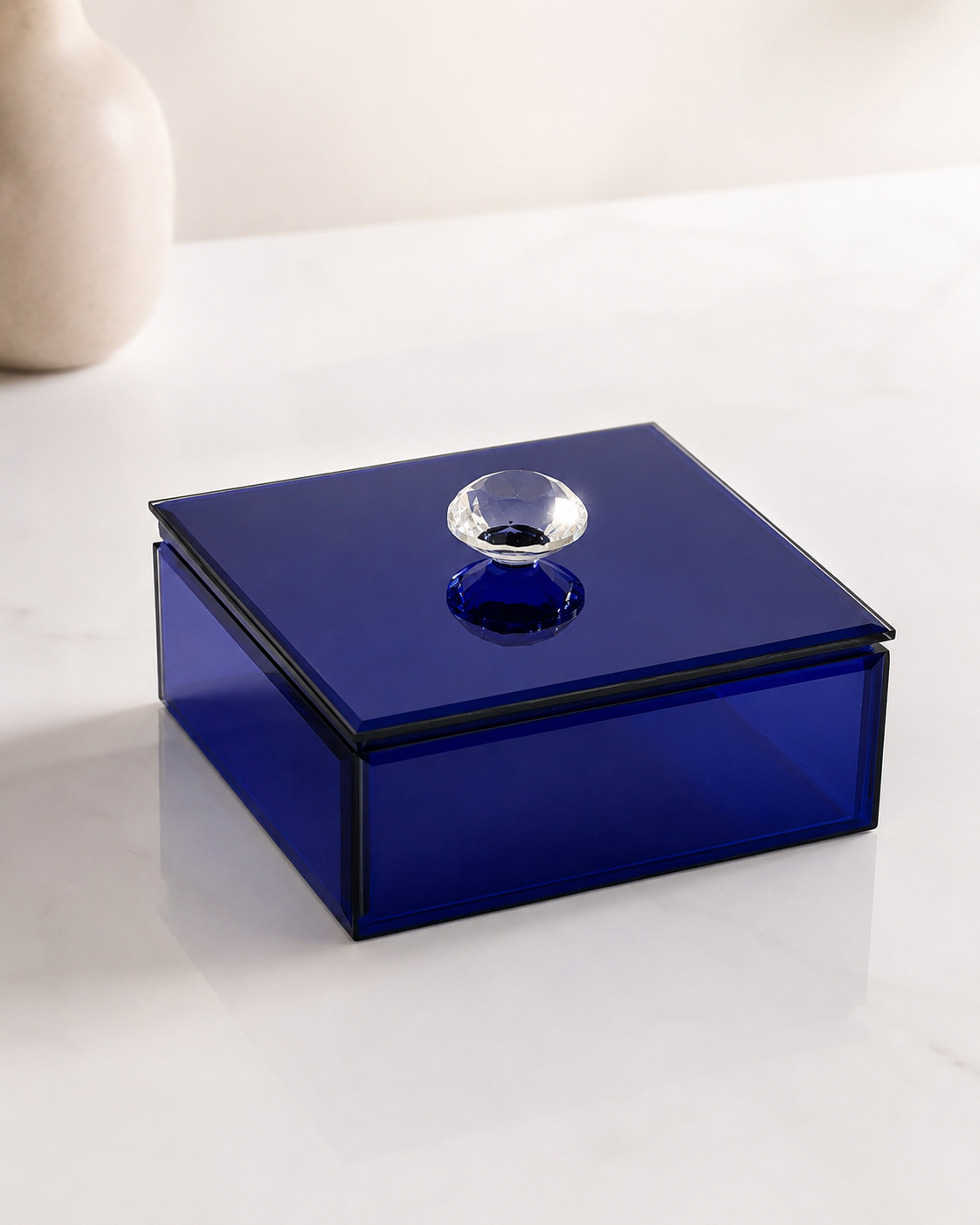 A deep blue square glass gift box with a glossy finish and decorative crystal-style knob, suitable for jewellery, chocolates, candles, keepsakes, and premium gifting.