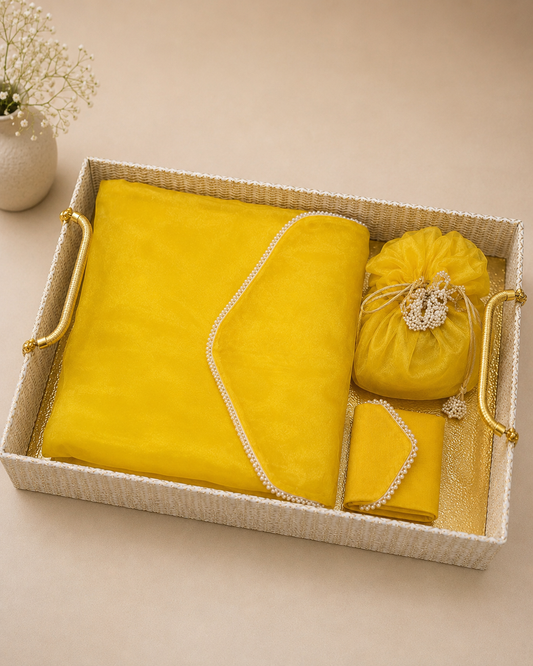 A yellow saree cover platter with matching fabric covering and decorative pouch, arranged in a rectangular gift tray, ideal for bridal trousseau, Haldi ceremonies, and wedding gifting.