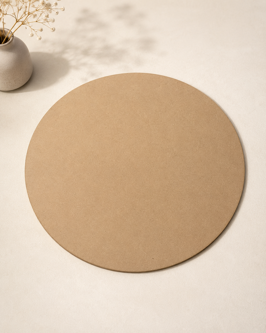 A smooth round MDF board with a natural wood finish, designed as a durable base for gift hampers, floral arrangements, DIY crafts, and customised packaging.