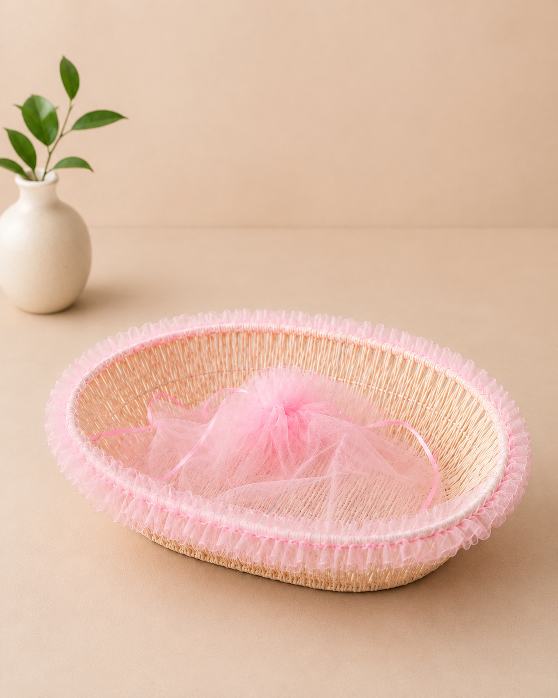 A shallow pink net tokri with a delicate woven texture, suitable for baby shower favours, bridal shower gifts, flowers, chocolates, sweets, and small hampers.