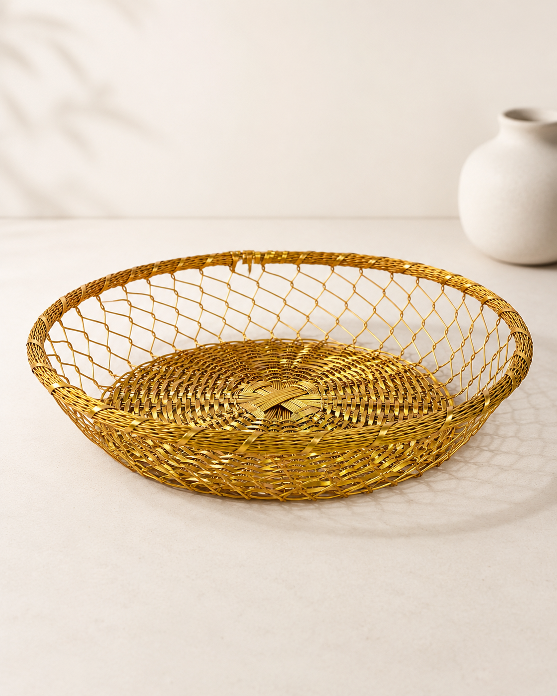 A wide shallow golden wire tokra with an open mesh design, available in small and big sizes, suitable for sweets, dry fruits, chocolates, flowers, and festive gift arrangements.