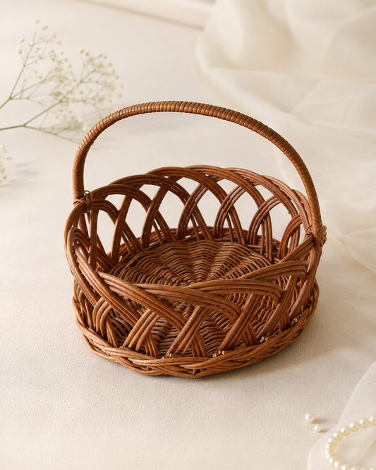 A large round cane hamper basket with an arched handle and natural woven design, ideal for wedding hampers, festive gifting, corporate gifts, and curated gift sets.