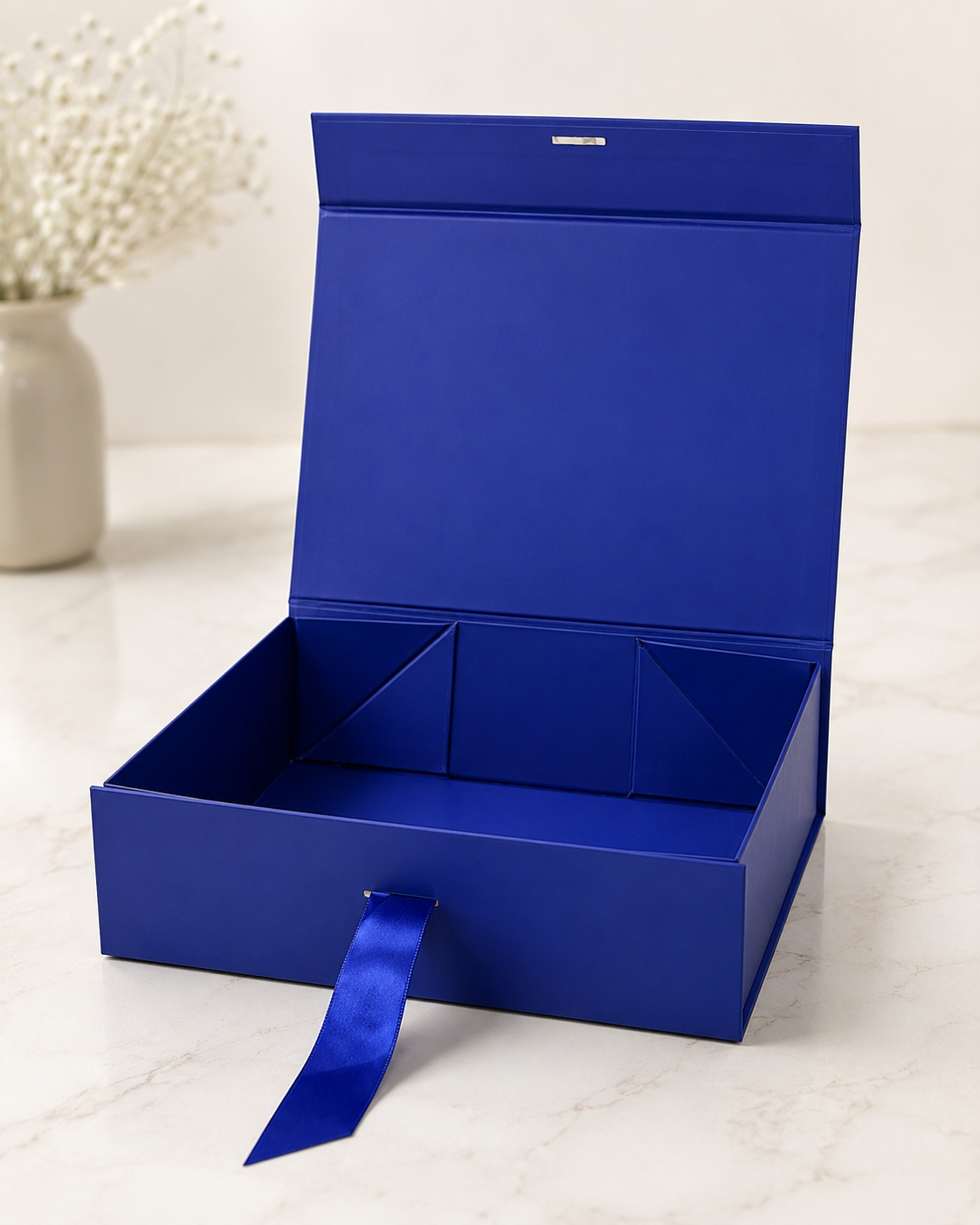 A blue collapsible gift box with a structured interior and hinged lid, designed for corporate hampers, employee gifts, festive collections, and curated gift packaging.