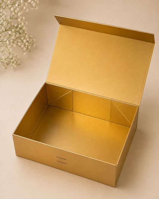 A golden collapsible gift box with a structured interior and hinged lid, designed for wedding hampers, premium festive gifts, luxury assortments, and curated gift packaging.