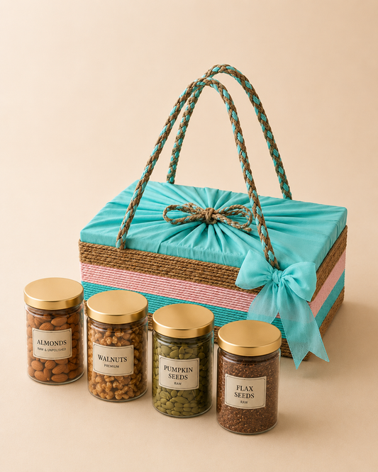 The Good Times Box featuring almonds, walnuts, pumpkin seeds, flax seeds, four golden-lid jars, and a teal suti covered box with ribbon detailing.