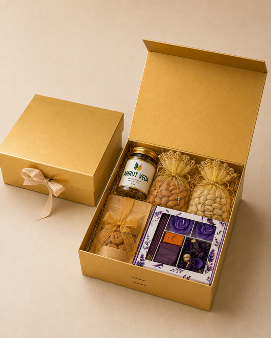 Golden Harmony Hamper arranged in a golden collapsible box with wellness products, almond pot, cashew pot, cookies, fragrance set, filler, and ribbon.