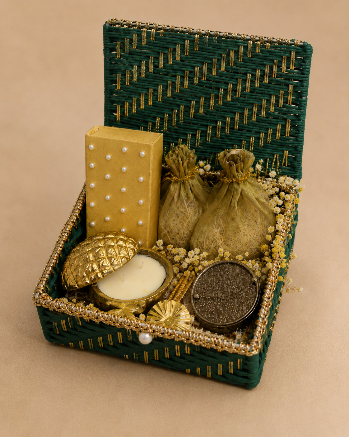Festive Treasure Trunk in a premium green wedding trunk featuring a cash box, scented candle, two dry-fruit potlis, decorative barrel, flowers, net, and fillers.