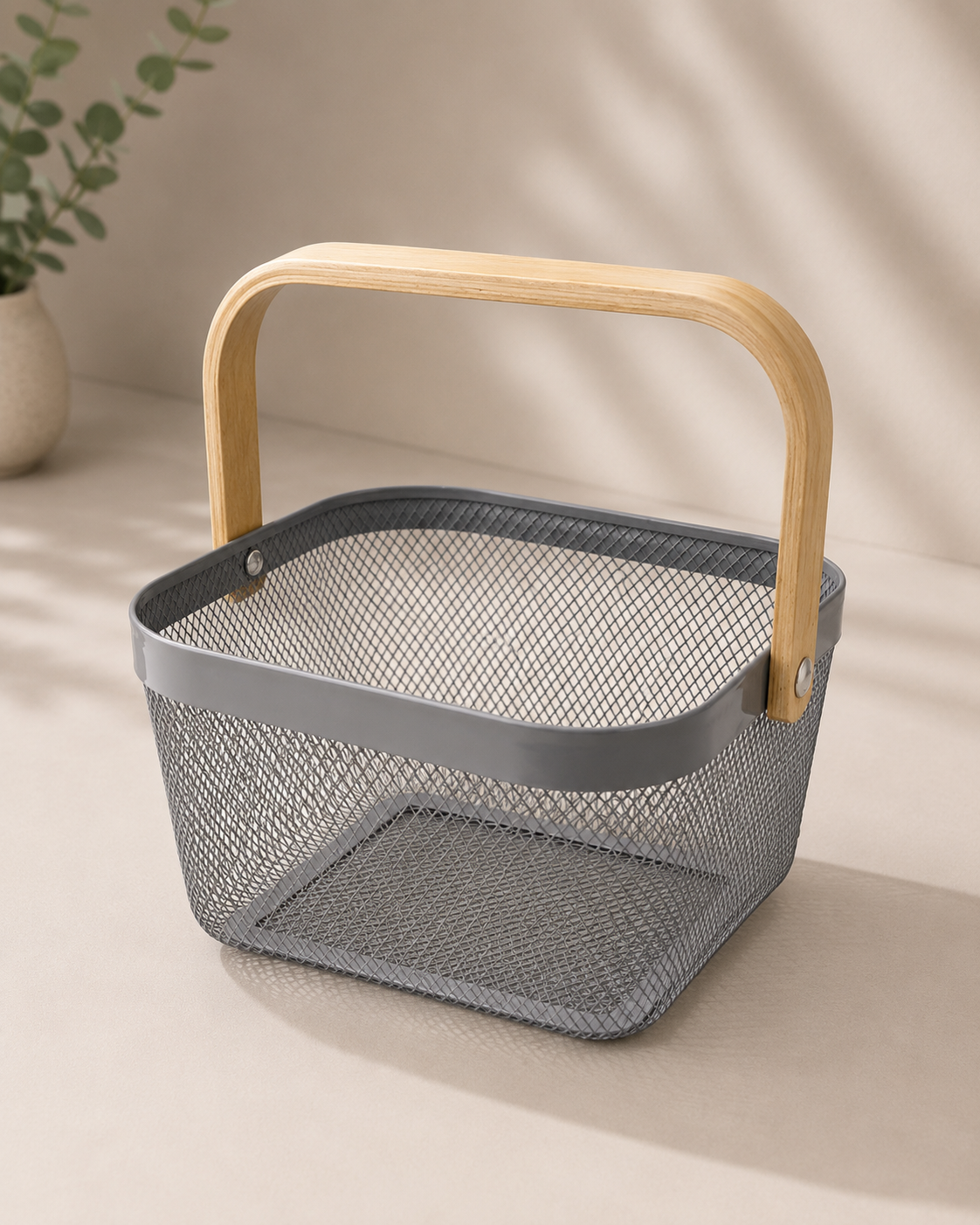 A grey square metal basket with a fine mesh texture and smooth wooden handle, suitable for corporate hampers, stationery, candles, beauty products, and modern gift arrangements.